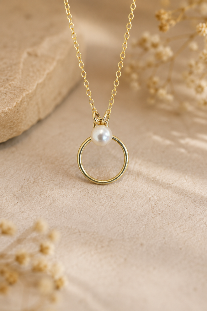 14K gold-filled circle necklace featuring a genuine 4.5mm white freshwater pearl on an adjustable 16 to 18 inch cable chain.