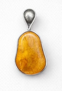 Handcrafted sterling silver amber pendent with leaf-inspired textured detailing and natural inclusions.