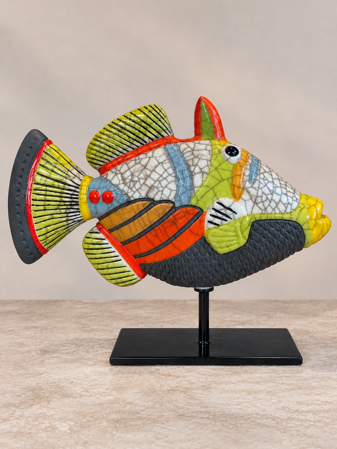 Orange and lime green handmade Raku ceramic Picasso fish sculpture with crackle glaze on black metal stand