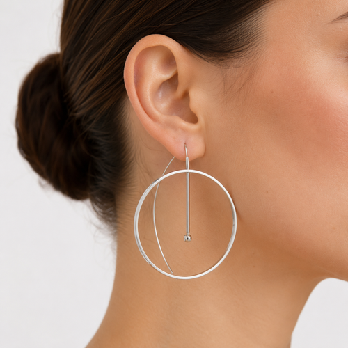 Large silver hoop earring on a model