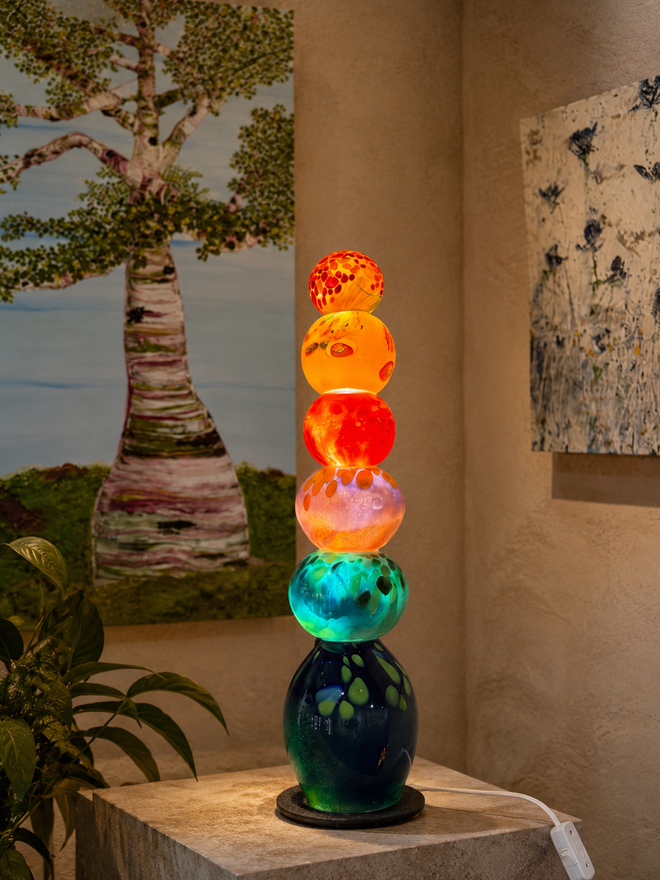 Lifestyle image of glass tower at corner space fixed with LED light