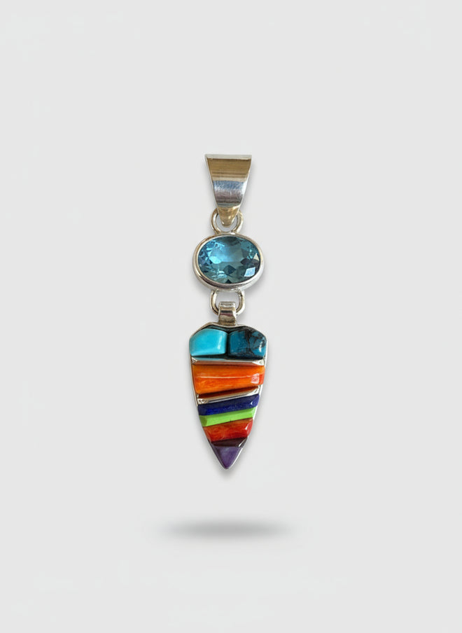 A colorful inlay necklace with a sterling silver pendant, featuring a combination of blue topaz, turquoise, spiny oyster, sugilite, gaspeite, and lapis