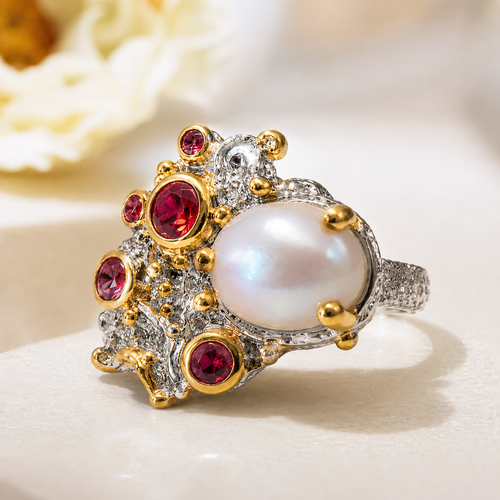 One-of-a-kind pearl and sapphire cluster ring featuring a luminous pearl surrounded by colorful sapphires in an artisan handcrafted setting.