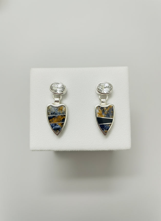 A pair of sterling silver earrings featuring Pietersite and Cubic Zirconia inlay, displayed against a black background.