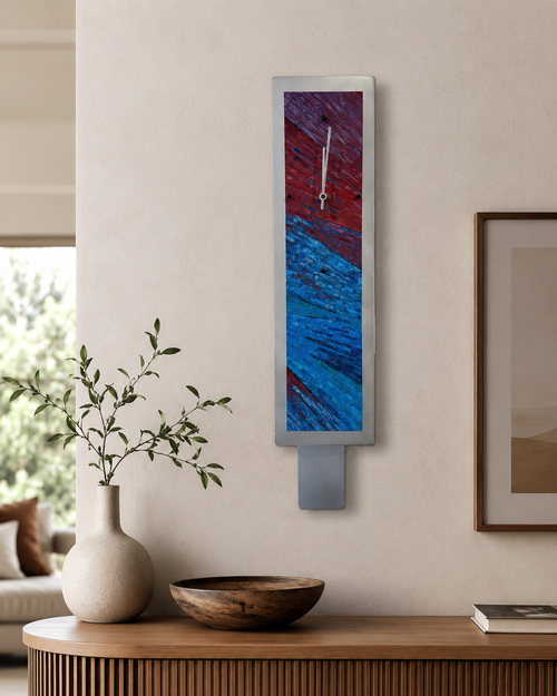 Hand-painted aluminum pendulum wall clock displayed in a modern home interior, featuring burgundy, purple, blue, and teal abstract artwork.