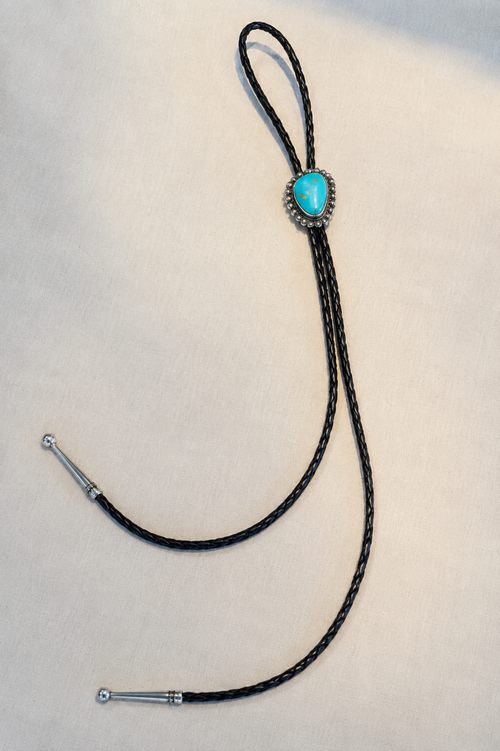 Full length Arizona Kingman turquoise bolo tie with sterling silver setting, black braided leather cord and silver tips