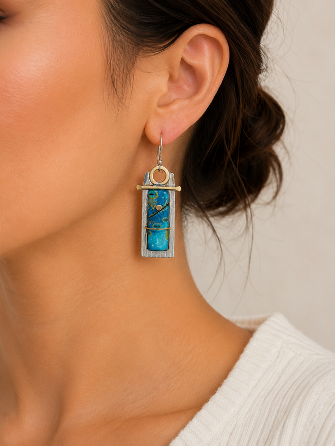 Turquoise-blue art glass artisan earrings shown on model ear, lightweight handmade sterling silver and brass dangle earrings.