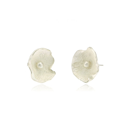 Close-up of handcrafted artisan sterling silver flower earrings featuring genuine freshwater pearls