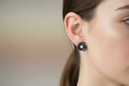 Artisan oxidized sterling silver flower stud earrings with genuine freshwater pearls in a sculptural handcrafted design for everyday elegance.
