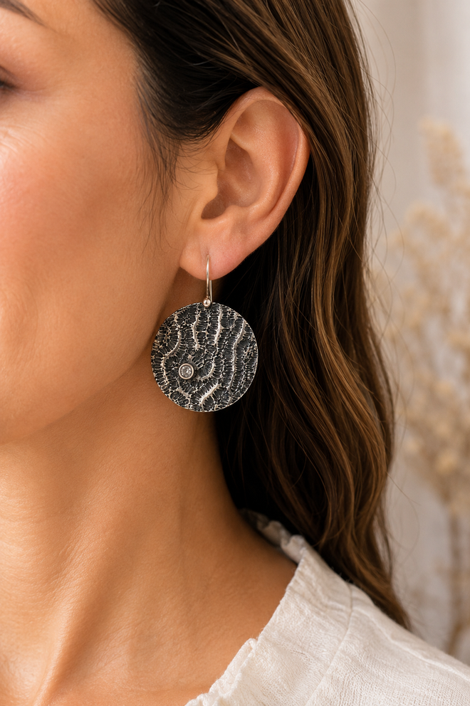 Handmade artisan sterling silver earrings worn elegantly handcrafted in Sedona Arizona fine jewelry with cubic zirconia accents