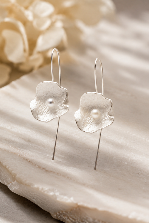 handcrafted sterling silver floral French wire earrings with genuine freshwater pearls in a lightweight contemporary artisan style.