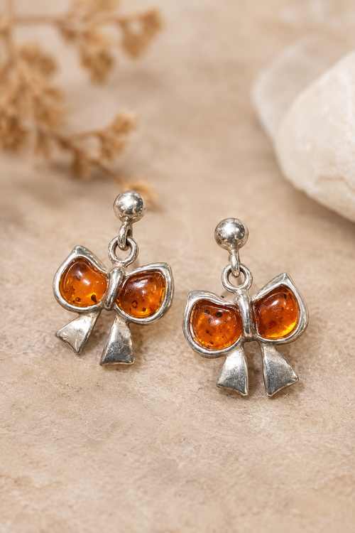 Natural Baltic amber bow earrings in sterling silver with cognac amber