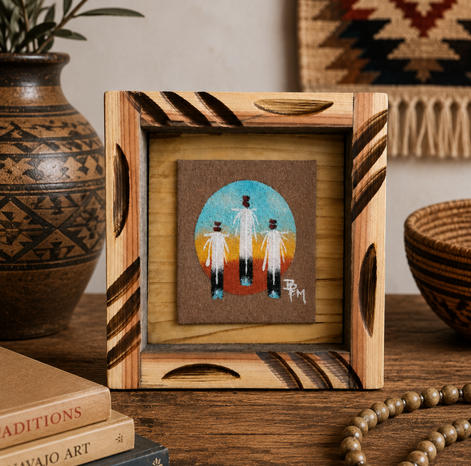 Authentic Ben Mitchell Navajo sand painting with three eagle feathers showcased in a rustic Southwestern interior with pottery and natural décor.