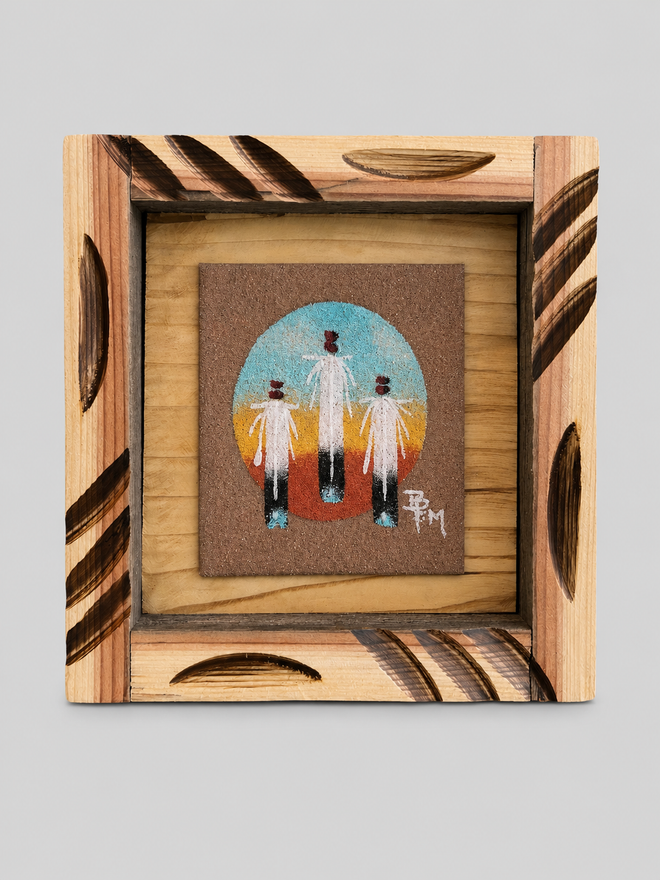 Original Navajo sand painting by Ben Mitchell featuring three eagle feathers against a desert-inspired background in a hand-carved wooden frame.