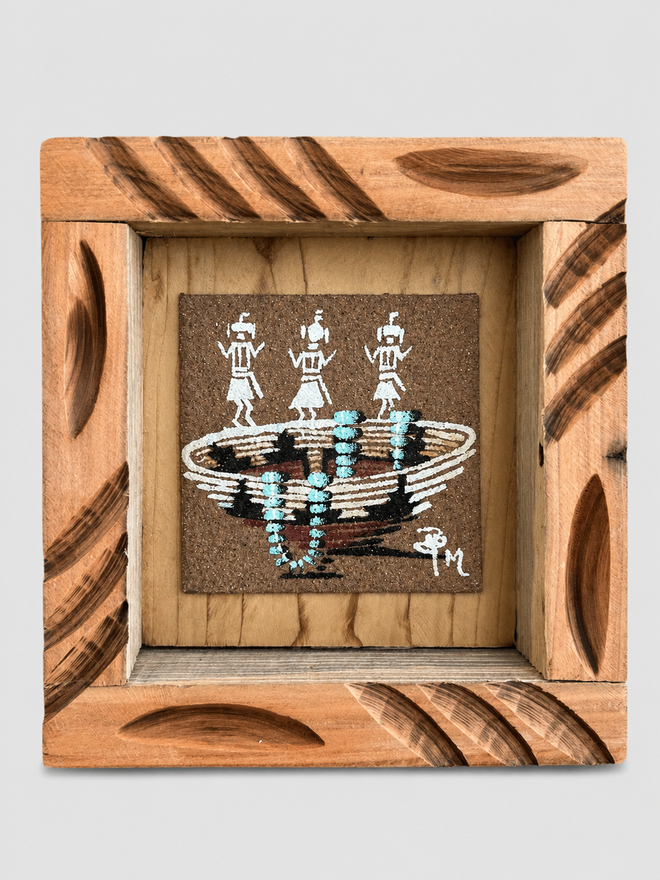 Original Navajo sand painting by Ben Mitchell featuring a Wedding Basket with turquoise necklace and three traditional figures in a hand-carved wooden frame
