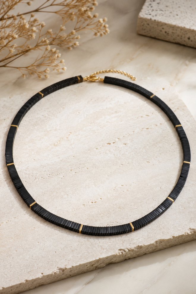 Handmade 18-inch black hematite necklace featuring 6x6mm square hematite beads with 18K gold-plated sterling silver accent beads on a white jewelry display. Elegant minimalist statement necklace for women.