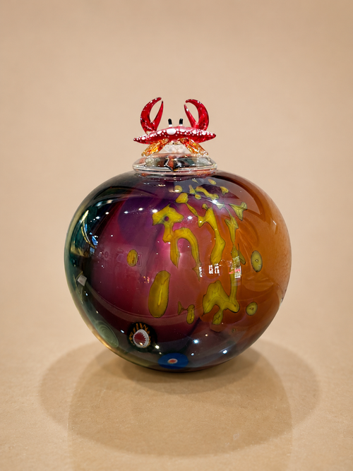 blown glass lidded vase with glass crab on top