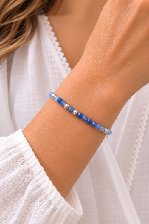 Model wearing a handcrafted blue aventurine bracelet with natural blue aventurine gemstones and matte sterling silver beads, elegant artisan jewelry for women.