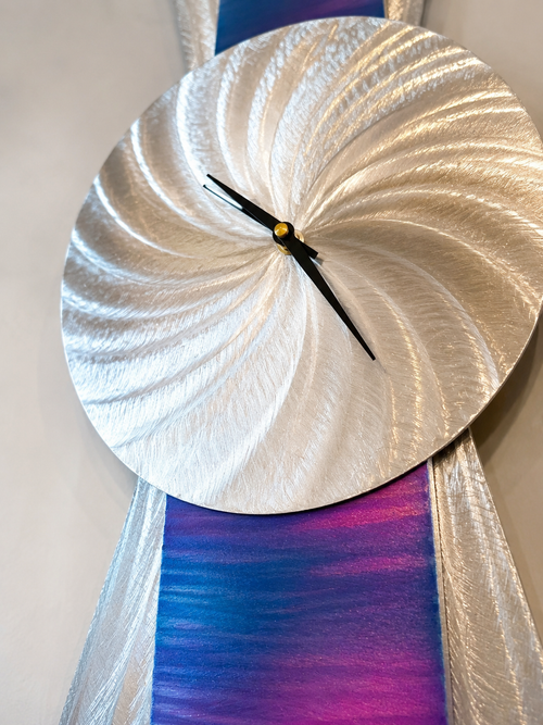 Close-up detail of blue purple and magenta patina finish on handcrafted aluminum wall clock