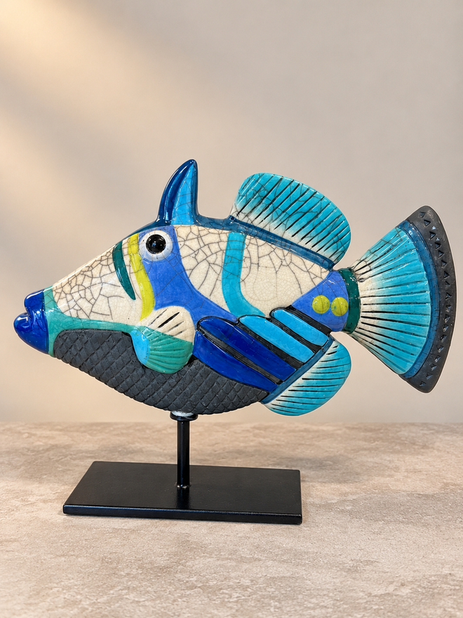 Blue and turquoise handmade Raku ceramic Picasso fish sculpture with crackle glaze on black metal stand