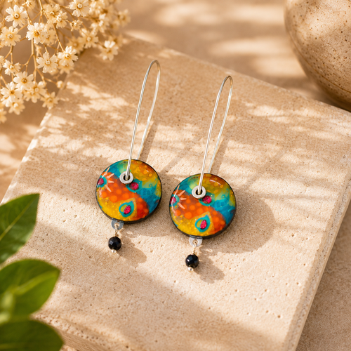 Bright round dangle earrings featuring colorful orange, blue, yellow, and green accents.