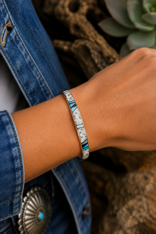 Buffalo Turquoise sterling silver cuff bracelet by Native American artist Wilber Tso shown on wrist
