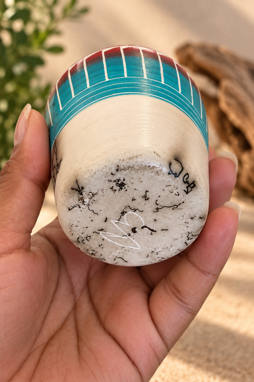 Underside of Cecelia Benally Navajo pottery showing the artist signature and natural horsehair markings