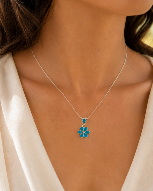 Chrysocolla flower necklace worn on neck with delicate sterling silver chain and blue green pendant