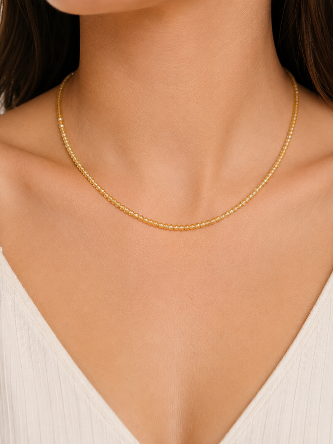 Natural citrine gemstone necklace worn on model featuring faceted golden beads