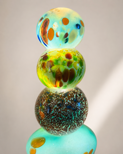Close up of aqua multicolor handblown glass light tower showing one of a kind glass details