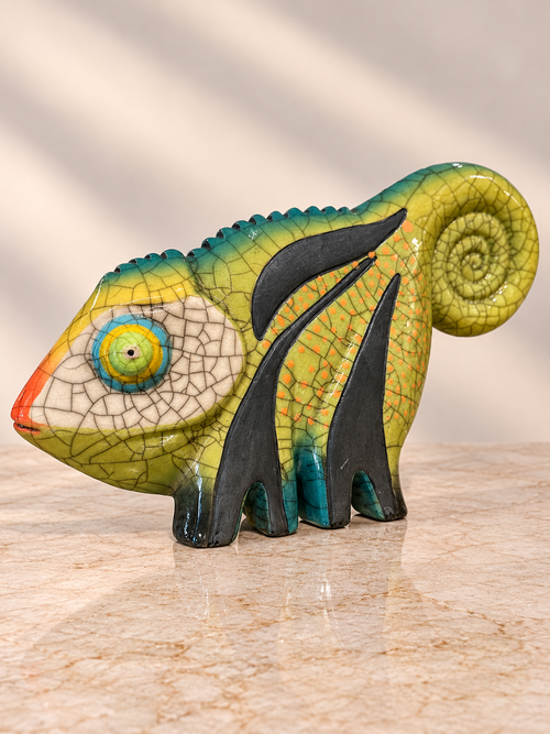 Colorful Raku ceramic lizard sculpture with green glaze, orange accents and spiral tail