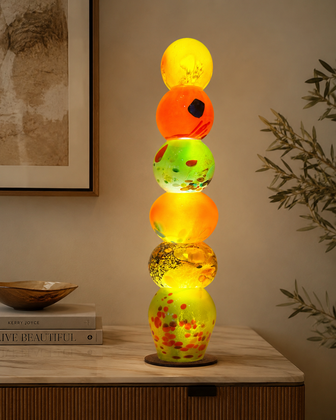 Colorful handblown glass light tower displayed as illuminated art lighting in a home setting