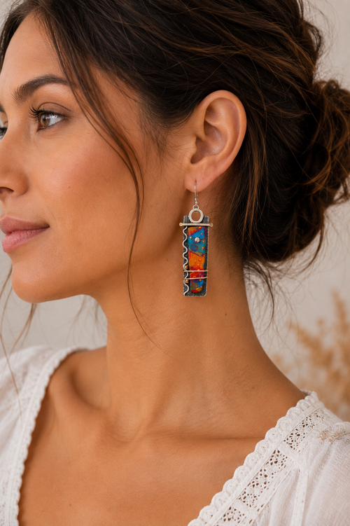 Long colorful statement earrings shown on model ear, lightweight sterling silver dangle earrings for women.