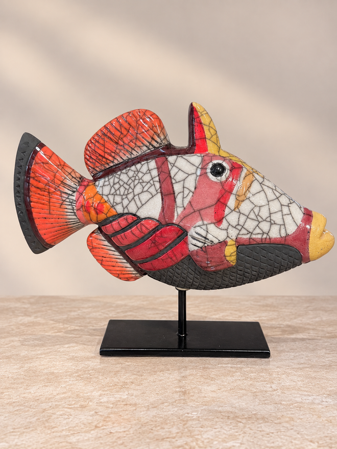 Coral red handmade Raku ceramic Picasso fish sculpture with crackle glaze on black metal stand