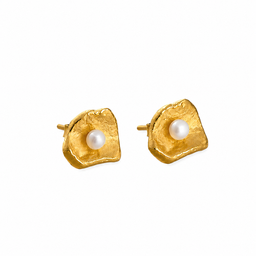 Close-up of handcrafted gold vermeil shell stud earrings with genuine freshwater pearls, contemporary designer jewelry made from sterling silver with an organic sculptural finish.