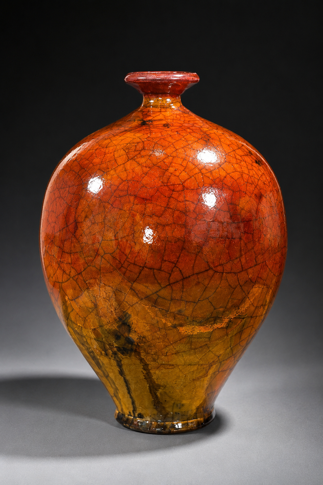 Handmade ferric chloride Raku pottery bottle with rich orange and rust tones