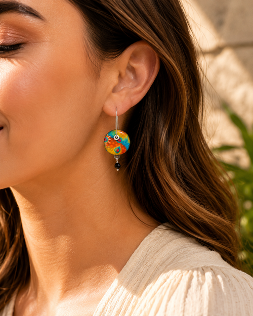 Fun colorful earrings for women shown on model ear with vibrant multicolor design.