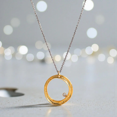 Gold-filled sterling silver circle necklace with cubic zirconia on an oxidized sterling silver adjustable chain