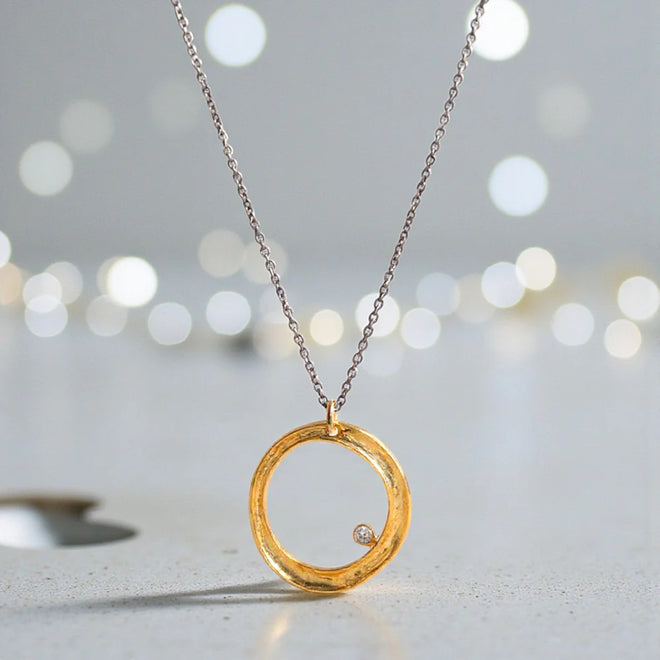 Gold-filled sterling silver circle necklace with cubic zirconia on an oxidized sterling silver adjustable chain
