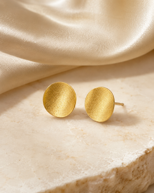 Gold plated sterling silver curved disc stud earrings with textured finish