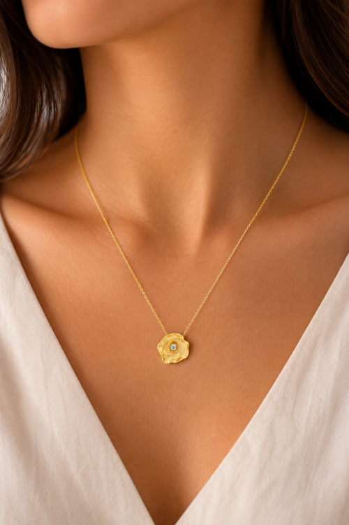 Woman wearing a handcrafted gold vermeil petal pendant necklace with cubic zirconia, elegant minimalist sterling silver jewelry and thoughtful gift for her.