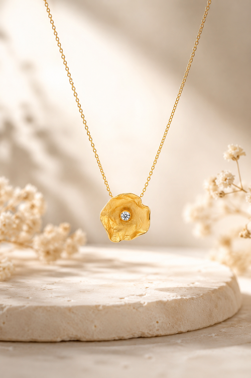 Handmade gold vermeil petal pendant necklace featuring a sparkling cubic zirconia on a sterling silver chain, elegant minimalist jewelry for women.