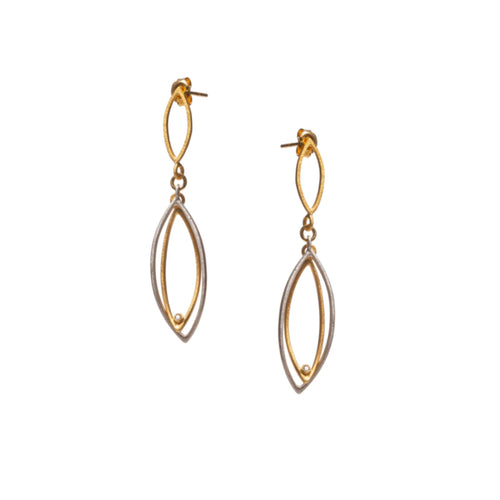 Handmade sterling silver and 18 carat gold vermeil marquise earrings with white cubic zirconia accents shown on ear for size reference.