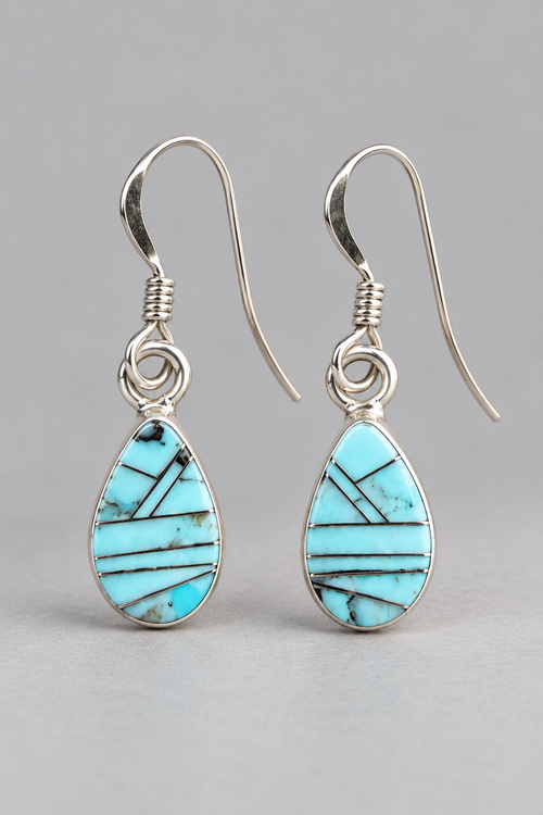 Petite Golden Hills turquoise earrings in sterling silver featuring pale sky-blue stones, delicate geometric silver inlay and French hooks.