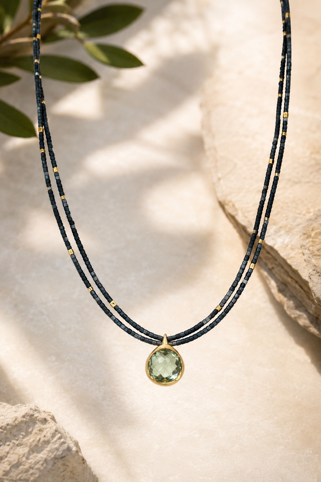 Handmade Green Amethyst pendant necklace featuring a double strand of 1.5mm square hematite beads, gold-plated accent beads, and a gold-plated sterling silver pendant with a magnetic clasp.