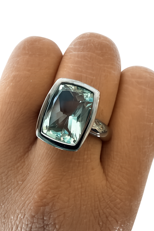 Handmade rectangular green amethyst ring in sterling silver photographed on soft luxury background by Raku Gallery in Jerome Arizona