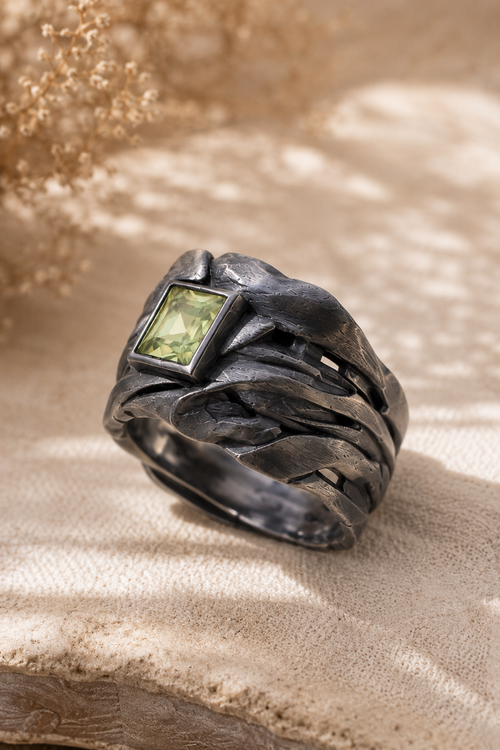 Side view of a handmade oxidized sterling silver Green Amethyst ring showcasing the sculptural wide band and 4mm square Green Amethyst bezel setting.