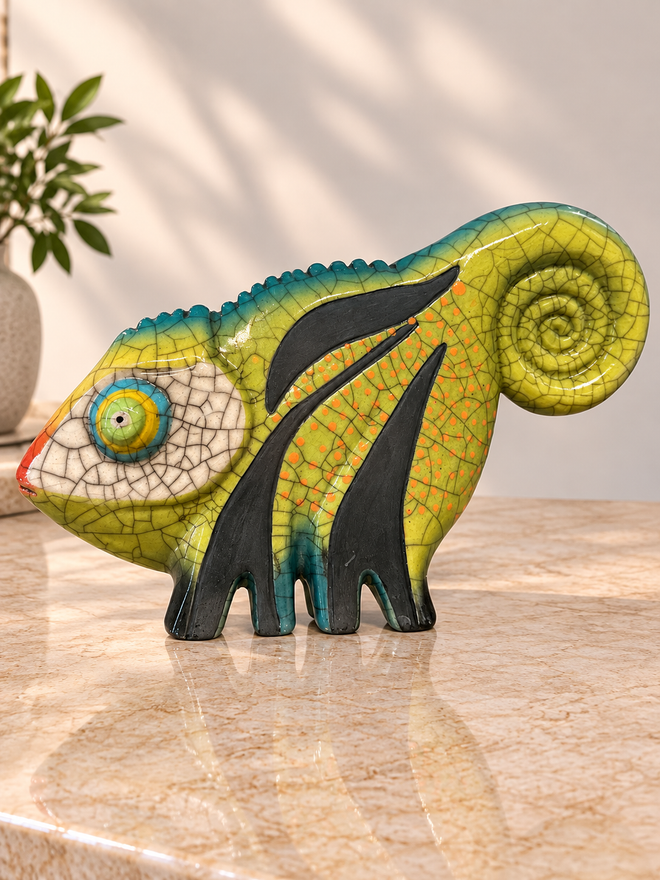 Green Raku chameleon ceramic sculpture showing colorful glaze, sculpted details and curled tail