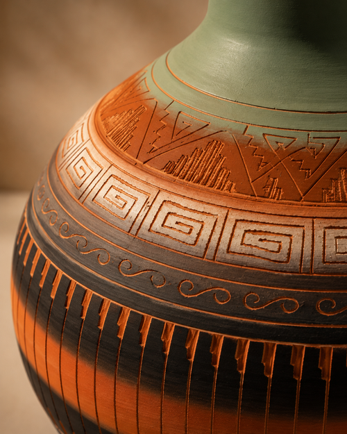 Close-up detail of hand carved geometric patterns on Navajo ceramic pottery
