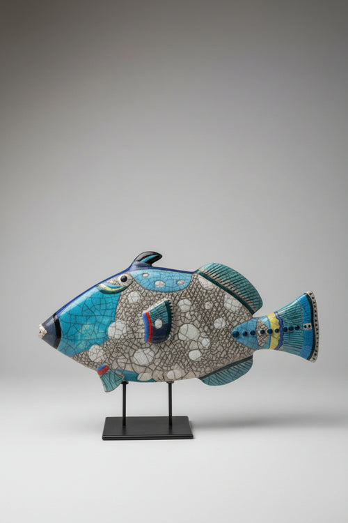 Handcrafted Raku ceramic Triggerfish sculpture with blue crackle glaze on a metal stand, one-of-a-kind coastal fish art for beach house and ocean-inspired home décor.